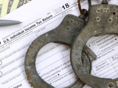 https://www.vecteezy.com/photo/13613333-police-handcuffs-lie-on-the-tax-form-1040-the-concept-of-problems-with-the-law-in-the-aftermath-of-non-payment-of-taxes