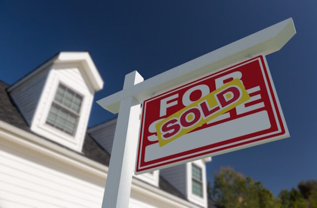 Sold For Sale Real Estate Sign in Front of New House. https://www.vecteezy.com/photo/21927879-sold-for-sale-real-estate-sign-in-front-of-new-house