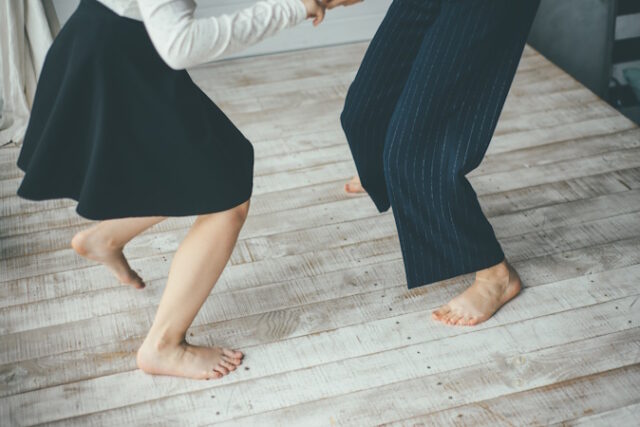 Two young woman dancing barefoot on the white floor https://www.vecteezy.com/photo/2245067-two-women-dancing