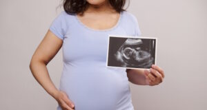 https://www.vecteezy.com/photo/23731196-cropped-view-pregnant-woman-caressing-her-belly-showing-at-camera-the-newborn-baby-ultrasound-scan-over-white-backdrop