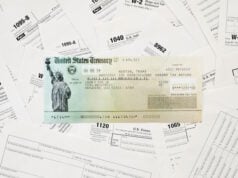 https://www.vecteezy.com/photo/15039603-refund-check-on-many-tax-form-blanks-lies-on-table-close-up-tax-payers-paperwork-routine-and-bureaucracy-concept
