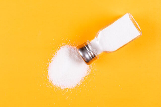 Sea salt coming out of salt shaker on a orange background. flat lay. https://www.freepik.com/free-photo/sea-salt-coming-out-salt-shaker_7417558.htm#fromView=search&page=1&position=34&uuid=cd1b445e-e47e-4557-bd4a-bdc288822416