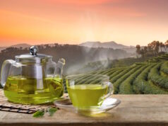 https://www.vecteezy.com/photo/11598870-cup-of-hot-green-tea-and-glass-jugs-or-jars-and-reen-tea-leaf-on-the-wooden-table-and-the-tea-plantations-background