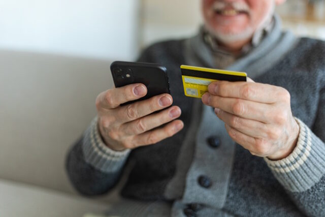 Senior man shopping online holding smartphone paying with credit card Old grandfather buying on Internet enter credit card details. Online shopping delivery service. Older generation modern tech usage https://www.vecteezy.com/photo/34942466-senior-man-shopping-online-holding-smartphone-paying-with-credit-card-old-grandfather-buying-on-internet-enter-credit-card-details-online-shopping-delivery-service-older-generation-modern-tech-usage
