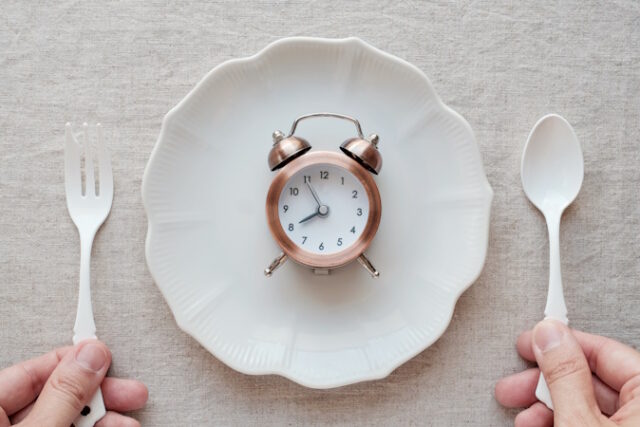 Hands holding fork and spoon and a clock on the plate, Intermitt https://www.freepik.com/premium-photo/hands-holding-fork-spoon-clock-plate-intermittent-fasting-diet-concept_4100680.htm#fromView=search&page=1&position=36&uuid=33ceaf7d-f82f-4da9-aa47-3654696e0151