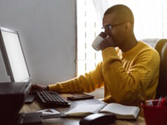 https://www.vecteezy.com/photo/42233027-latin-american-young-adult-man-have-a-cup-of-coffee-while-working-on-his-desktop-computer