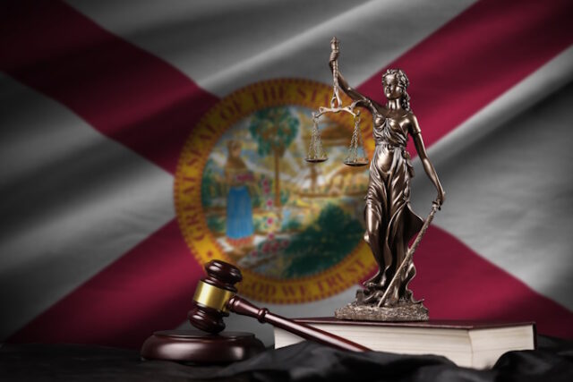 Florida US state flag with statue of lady justice, constitution and judge hammer on black drapery. Concept of judgement and guilt https://www.vecteezy.com/photo/13837026-florida-us-state-flag-with-statue-of-lady-justice-constitution-and-judge-hammer-on-black-drapery-concept-of-judgement-and-guilt