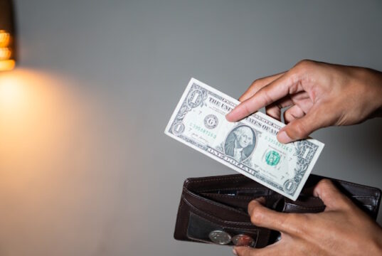 https://www.vecteezy.com/photo/46779179-person-holding-a-one-dollar-bill-and-a-wallet-with-coins