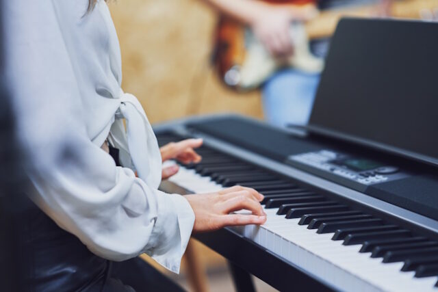 Caucasian woman playing on keyboard with band https://www.vecteezy.com/photo/15867479-caucasian-woman-playing-on-keyboard-with-band