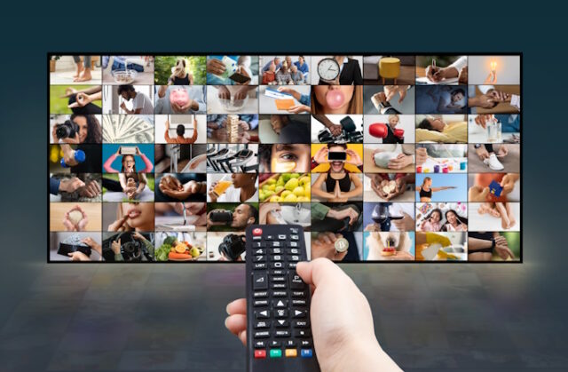 A Hand Holding a Remote Control in Front of a Television https://www.freepik.com/premium-photo/hand-holding-remote-control-front-television_294260954.htm#fromView=search&page=1&position=9&uuid=ef90cf49-7ced-428f-a721-66b1a8f84e25