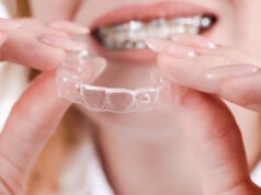 https://www.vecteezy.com/photo/31153902-dental-care-smiling-girl-with-braces-on-her-teeth-holds-aligners-in-her-hands-and-shows-the-difference-between-them