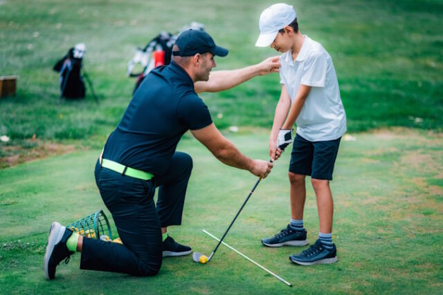 Golf Lessons. Golf instructor giving game lesson to a young boy. https://www.freepik.com/premium-photo/golf-lessons-golf-instructor-giving-game-lesson-young-boy_37716411.htm#fromView=search&page=1&position=42&uuid=6a39843f-893d-49e6-b24d-9abf7746e79e&query=golf+school