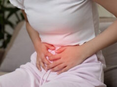 https://www.vecteezy.com/photo/47155127-woman-experiencing-stomach-pain-while-sitting-on-a-couch-in-a-home-setting-clutching-her-abdomen-in-discomfort