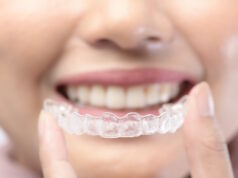 https://www.vecteezy.com/photo/5345459-young-smiling-woman-holding-invisalign-braces-over-white-background-studio-dental-healthcare-and-orthodontic-concept