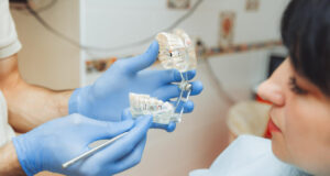 https://www.freepik.com/premium-photo/male-orthodontist-dentist-shows-artificial-plastic-jaw-patient-sitting-dentist-s-chair-medical-treatment-enamel_28802735.htm#from_element=cross_selling__photo