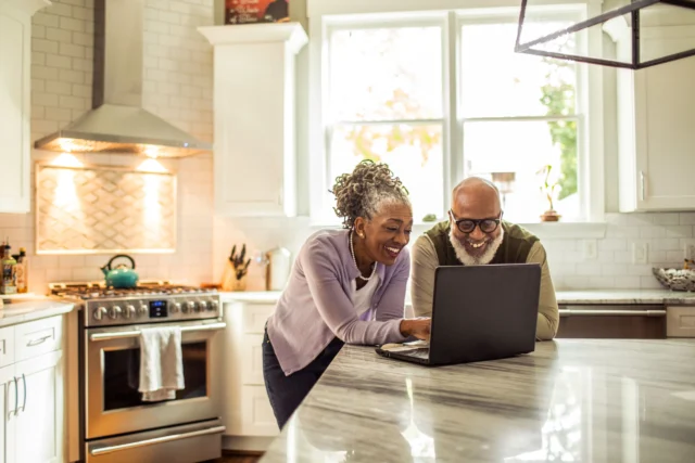 Insurance-Home-Save-Money https://www.vecteezy.com/photo/58344437-senior-married-couple-watching-movie-together-on-laptop-near-rv-at-campground-panorama