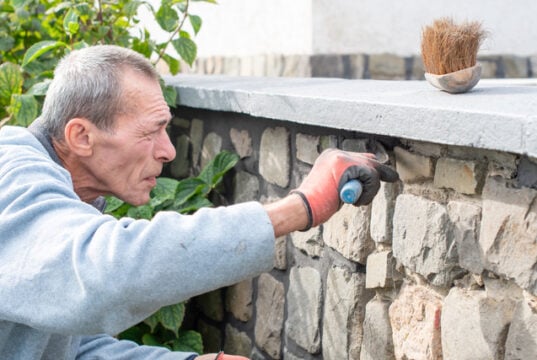 https://www.vecteezy.com/photo/65976083-a-builder-carefully-applies-cement-between-the-stones-of-a-wall-with-a-narrow-trowel-restoring-the-appearance-of-a-historic-building-using-professional-methods-and-tools