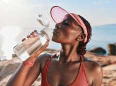 https://www.vecteezy.com/photo/51234207-a-fit-woman-in-a-cap-enjoying-water-from-a-bottle-with-a-serene-ocean-background-and-a-warm-sunny