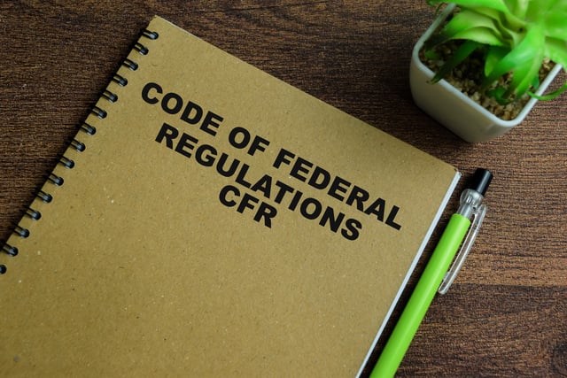 Concept of Code of Federal Regulations CFR write on book isolated on Wooden Table. https://www.vecteezy.com/photo/39949787-concept-of-code-of-federal-regulations-cfr-write-on-book-isolated-on-wooden-table