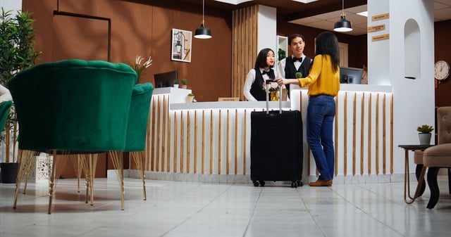 Asian woman approaching front desk in hotel lobby https://www.vecteezy.com/photo/38591157-asian-woman-approaching-front-desk-in-hotel-lobby-receptionist-asking-client-about-room-reservation-details-for-check-in-friendly-employee-welcoming-customer-at-reception-hospitality-industry