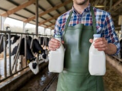 https://www.vecteezy.com/photo/54898192-dairy-worker-holding-milk-bottles-in-rustic-barn