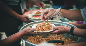 https://www.vecteezy.com/photo/44426704-volunteer-serving-food-to-the-homeless-in-the-community-charitable-donation-center-concept-of-free-food-assistance-service