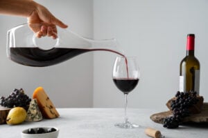 https://www.freepik.com/free-photo/side-view-hand-pouring-wine-glass_32517758.htm#fromView=search&page=1&position=9&uuid=2a525746-d8f3-44bf-8c0b-23a287f7ec4d&query=wine+decanting