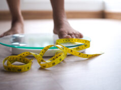 https://www.vecteezy.com/photo/19050447-a-woman-on-a-scale-the-yellow-tape-is-in-focus-weight-loss-diet-concept