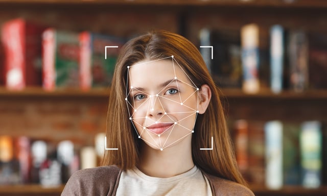 Facial recognition technology demonstrated on a young woman's face in a library https://www.vecteezy.com/photo/54857442-a-young-woman-smiles-as-facial-recognition-technology-analyzes-her-features-in-a-library-surrounded-by-books-the-focus-is-on-her-face-highlighting-advanced-id-technology-in-use