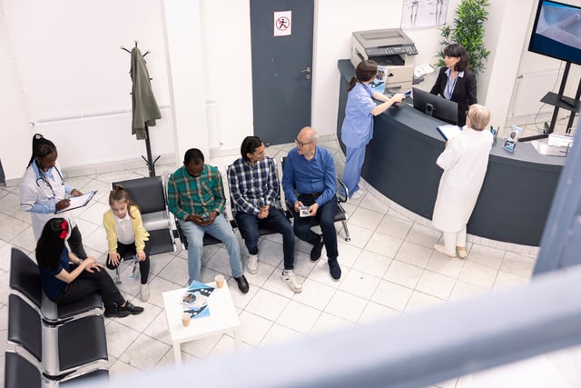 Diverse Patients Waiting for Medical Consultation https://www.vecteezy.com/photo/71392094-diverse-people-seated-in-waiting-room-preparing-for-clinical-consultations-elderly-man-and-asian-guy-engage-in-conversation-as-black-female-doctor-records-data-of-mom-and-daughter-in-hospital-lobby