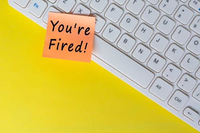 You're Fired text on orange sticky note on top of white keyboard. https://www.vecteezy.com/photo/7313946-you-re-fired-text-on-orange-sticky-note-on-top-of-white-keyboard
