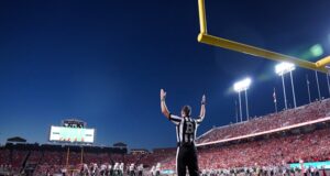 https://unsplash.com/photos/a-football-player-standing-on-a-field-with-his-arms-in-the-air-zZgq0_SqPtU