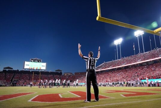 https://unsplash.com/photos/a-football-player-standing-on-a-field-with-his-arms-in-the-air-zZgq0_SqPtU