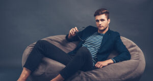 https://www.vecteezy.com/photo/13572739-stylish-and-handsome-confident-young-handsome-man-holding-his-sunglasses-and-looking-at-camera-while-sitting-on-beanbag-against-grey-background