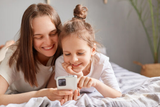 https://www.vecteezy.com/photo/74060086-smiling-mother-and-adorable-daughter-using-phone-relaxing-on-bed-at-home-curious-little-girl-child-with-mum-looking-at-smartphone-screen-browsing-apps
