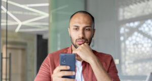 https://www.vecteezy.com/photo/69143619-man-engaged-with-smartphone-in-contemporary-office