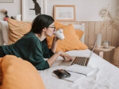 https://www.pexels.com/photo/woman-using-laptop-and-drinking-beverage-in-bed-4050415/