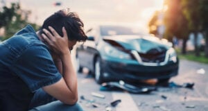 https://www.vecteezy.com/photo/43208510-a-man-sits-on-the-ground-next-to-a-car-that-has-been-in-an-accident