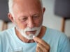 Low Dose Aspirin Not Tied to Cancer, but May Raise Cancer-Related Death Risk https://www.vecteezy.com/photo/39952777-senior-man-takes-pill-with-glass-of-water-in-hand-stressed-mature-man-drinking-sedated-antidepressant-meds-man-feels-depressed-taking-drugs-medicines-at-work