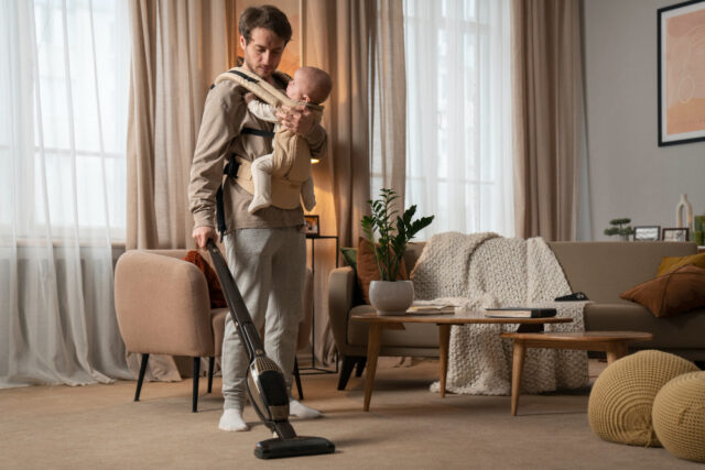 2150166590 https://www.freepik.com/free-photo/full-shot-father-holding-baby-while-vacuuming_38050050.htm