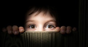 https://www.vecteezy.com/photo/72502944-child-s-curious-eyes-peeking-over-wooden-fence-fear-mystery-and-childhood