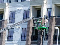 https://www.vecteezy.com/photo/49861512-construction-worker-on-boom-lift-painting-modern-building-exterior