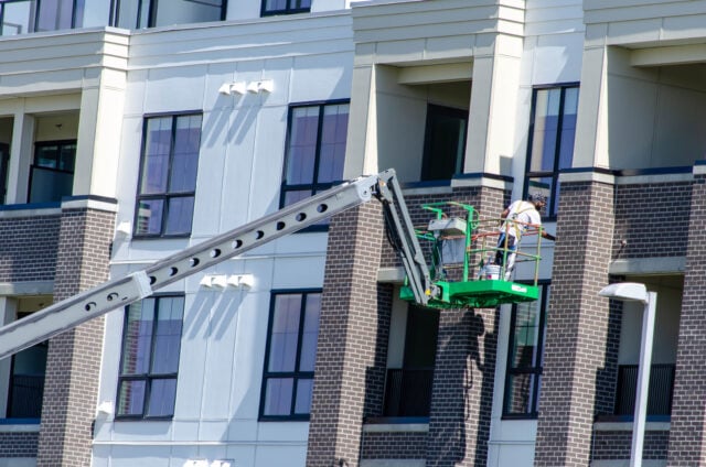 https://www.vecteezy.com/photo/49861512-construction-worker-on-boom-lift-painting-modern-building-exterior