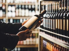 https://www.vecteezy.com/photo/73104289-faceless-person-holds-taking-from-shelf-bottle-of-wine-in-store-close-up