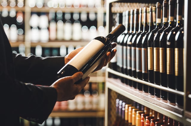 https://www.vecteezy.com/photo/73104289-faceless-person-holds-taking-from-shelf-bottle-of-wine-in-store-close-up