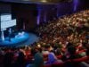 https://unsplash.com/photos/speaker-presenting-to-large-audience-in-auditorium-_96edJ8IVC4