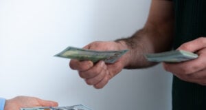 https://www.vecteezy.com/photo/73873674-close-up-of-transaction-with-dollar-bills-concept-of-debt-repayment-service-payment-or-money-lending