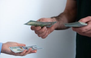 https://www.vecteezy.com/photo/73873674-close-up-of-transaction-with-dollar-bills-concept-of-debt-repayment-service-payment-or-money-lending