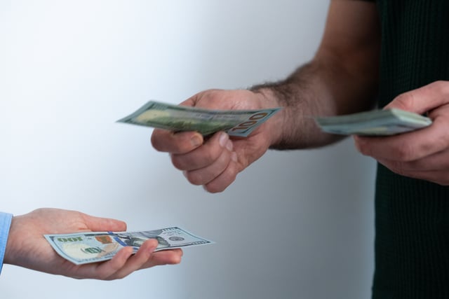 https://www.vecteezy.com/photo/73873674-close-up-of-transaction-with-dollar-bills-concept-of-debt-repayment-service-payment-or-money-lending