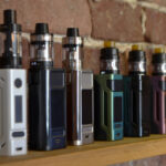 Electronic cigarette on a background of vape shop. E-cigarette for vaping.